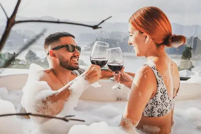 a man and woman drinking wine in a bathtub at GUATAPE By MONTE GANDOLFO in Chiquinquirá
