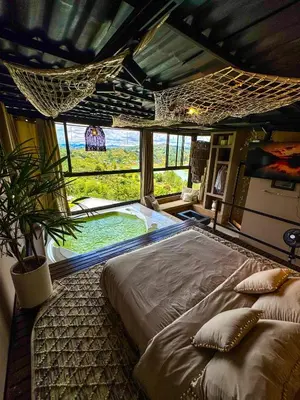 a large bed in a room with a large window at MORITZ By MONTE GANDOLFO in Chiquinquirá