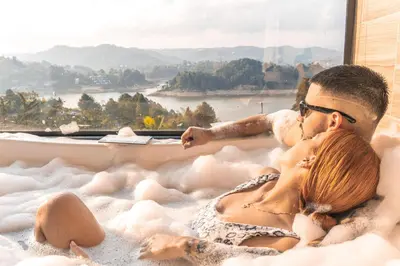 a man and woman laying in a bath tub with a view at MORITZ By MONTE GANDOLFO in Chiquinquirá