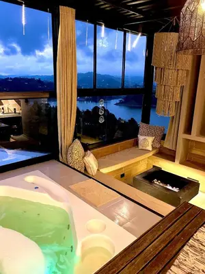 a bathroom with a jacuzzi tub in front of a window at MORITZ By MONTE GANDOLFO in Chiquinquirá