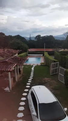 a white car parked next to a house with a swimming pool at Escapada Rural, Finca Espaciosa y Relajante en el Corazón de la Naturaleza in Sopetran