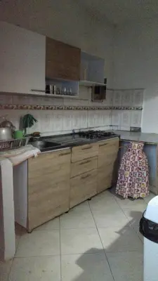 a kitchen with wooden cabinets and a stove top oven at Escapada Rural, Finca Espaciosa y Relajante en el Corazón de la Naturaleza in Sopetran
