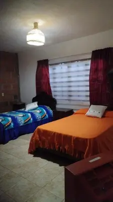 a bedroom with two beds and a window at Escapada Rural, Finca Espaciosa y Relajante en el Corazón de la Naturaleza in Sopetran
