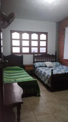 a bedroom with two beds and two windows at Escapada Rural, Finca Espaciosa y Relajante en el Corazón de la Naturaleza in Sopetran