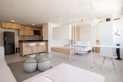 a kitchen with a table and chairs in a room at Elegant apt in Laureles The best area in Medellin in Medellín