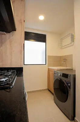 a kitchen with a washing machine and a window at Elegant apt in Laureles The best area in Medellin in Medellín