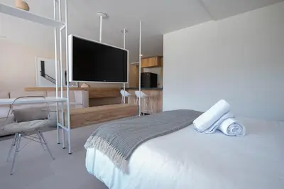 a bedroom with a bed and a flat screen tv at Elegant apt in Laureles The best area in Medellin in Medellín