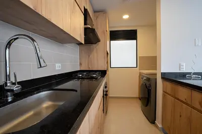 a kitchen with a sink and a counter top at Elegant apt in Laureles The best area in Medellin in Medellín
