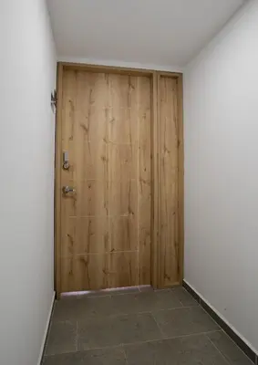 a wooden door in a room with a tile floor at Elegant apt in Laureles The best area in Medellin in Medellín