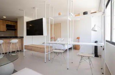 a kitchen and dining room with a table and chairs at Elegant apt in Laureles The best area in Medellin in Medellín