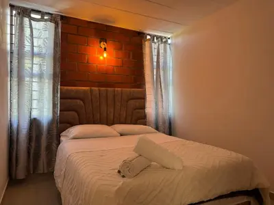 a bed with a towel on it in a bedroom at Casa Macrame El Carmen de Viboral in Carmen de Viboral