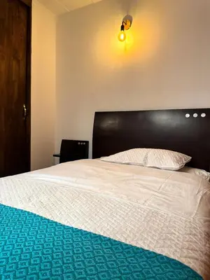 a bedroom with a bed with a black headboard at Casa Macrame El Carmen de Viboral in Carmen de Viboral