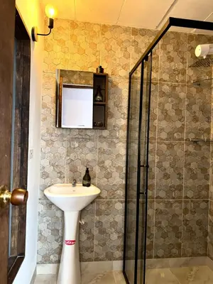 a bathroom with a sink and a shower at Casa Macrame El Carmen de Viboral in Carmen de Viboral