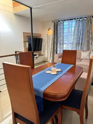 a dining room table with a blue napkin on it at Casa Macrame El Carmen de Viboral in Carmen de Viboral