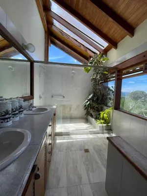 a bathroom with two sinks and a large window at Casa de Campo, La Suiza in La Ceja, Antioquia in La Ceja