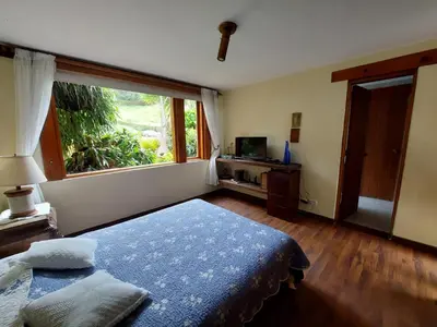a bedroom with a bed and a large window at Casa de Campo, La Suiza in La Ceja, Antioquia in La Ceja