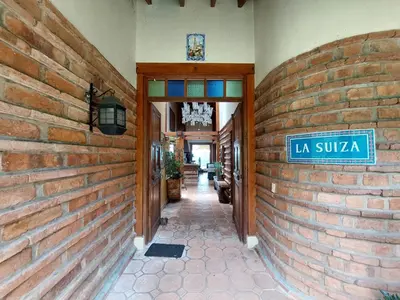 a building with a sign on a brick wall at Casa de Campo, La Suiza in La Ceja, Antioquia in La Ceja