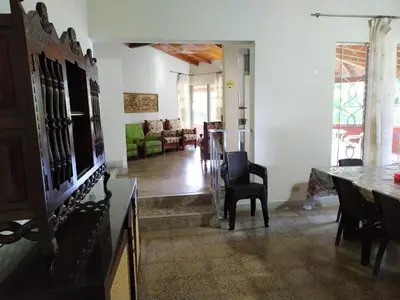 a living room with a table and a dining room at Finca Las Dos Palmas, San Jeronimo in San Jerónimo
