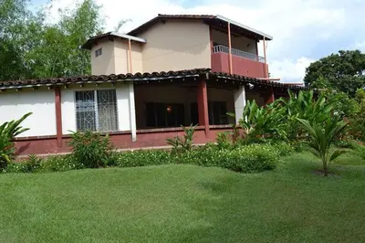 a house with a green lawn in front of it at Finca Las Dos Palmas, San Jeronimo in San Jerónimo