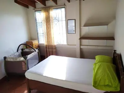 a bedroom with a large bed with a window at Finca Las Dos Palmas, San Jeronimo in San Jerónimo