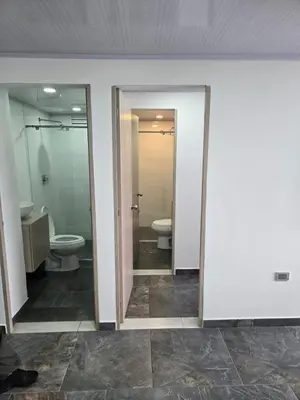 a bathroom with two toilets and two sinks at Vancouver 102 in Villamaría