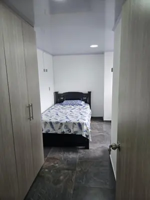 a bedroom with a bed in a white room at Vancouver 102 in Villamaría