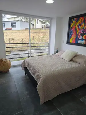 a bedroom with a bed with a painting on the wall at Vancouver 201 in Villamaría