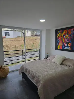 a bedroom with a bed and a painting of a lion at Vancouver 201 in Villamaría