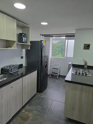 a kitchen with a black refrigerator and a stove at Vancouver 201 in Villamaría