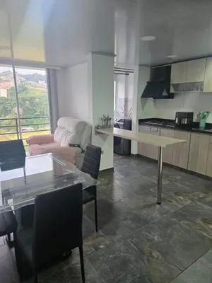a kitchen and living room with a table and chairs at Vancouver 402 in Villamaría