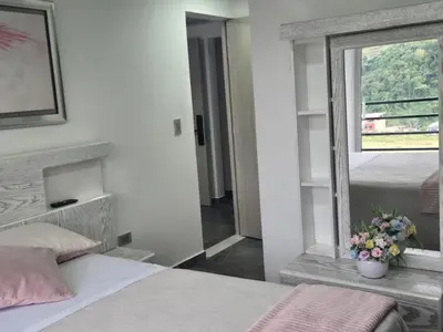 a bedroom with a bed with a mirror and a window at Vancouver 402 in Villamaría