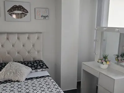 a room with a bed with a mirror and a vanity at Vancouver 402 in Villamaría