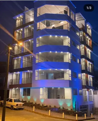 a blue building with a car parked in front of it at Vancouver 402 in Villamaría