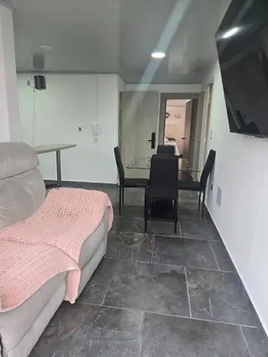 a room with two beds and a table and chairs at Vancouver 402 in Villamaría