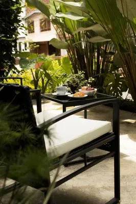 a black table with a white bench and a table with food on it at Bluelux Med - B&B in Medellín