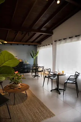 a room with tables and chairs in a building at Bluelux Med - B&B in Medellín