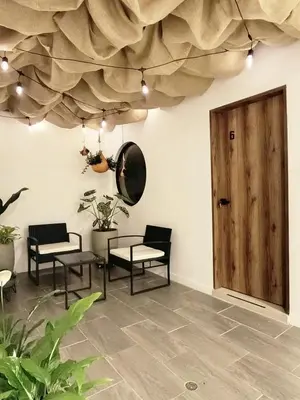 a room with chairs and a wooden ceiling at Bluelux Med - B&B in Medellín