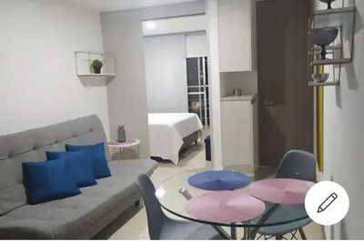 a living room with a couch and a glass table at Central apartamento en la Estrella in La Estrella