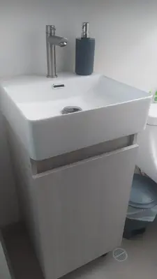 a white sink in a bathroom with a toilet at Central apartamento en la Estrella in La Estrella