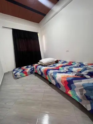 a bed with a colorful comforter in a room at Casa Luagua in San Rafael