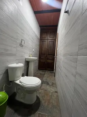 a bathroom with a toilet and a sink at Casa Luagua in San Rafael