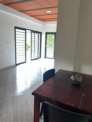 a dining room with a wooden table and chairs at Casa Luagua in San Rafael