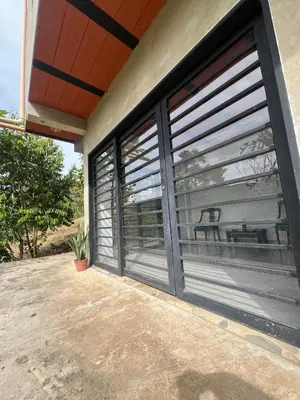 a pair of garage doors on the side of a house at Casa Luagua in San Rafael