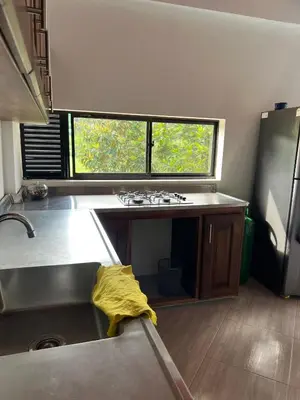 an empty kitchen with a sink and a window at Casa Luagua in San Rafael