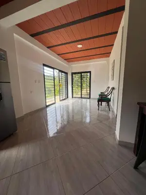 an empty room with a wooden ceiling with windows at Casa Luagua in San Rafael