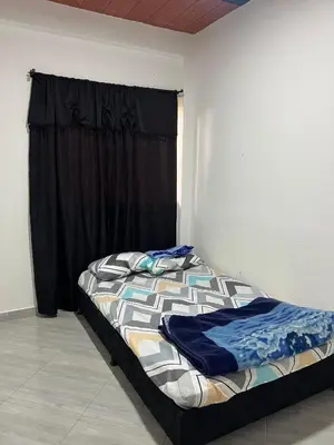 a bed in a room with a black curtain at Casa Luagua in San Rafael