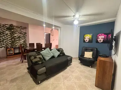 a living room with a couch and a chair at Apartamentos compostela in Medellín