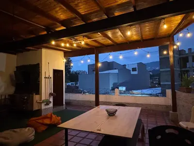 a table on a patio with a view of a building at Apartamentos compostela in Medellín