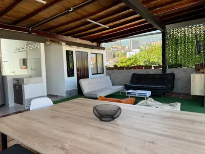 a living room with a table and a couch at Apartamentos compostela in Medellín