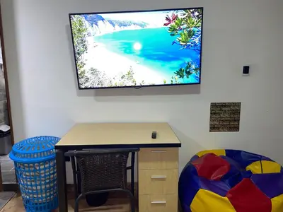a room with a desk and a tv on the wall at Coliving Belen Malibu in Medellín